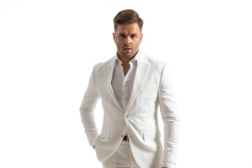portrait of confident businessman with open collar shirt in white suit