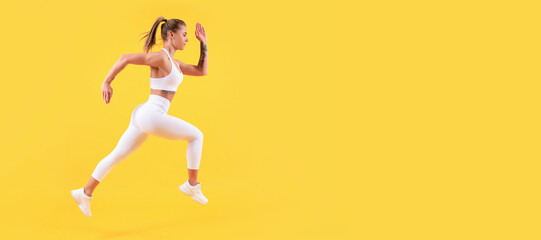 Fototapeta na wymiar energetic fitness woman runner running on yellow background. Woman jumping running banner with mock up copyspace.