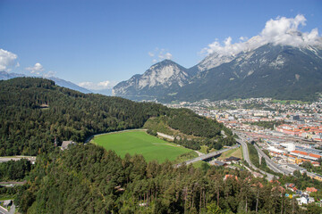 Fototapeta na wymiar View of the city of Innsbruck, the capital of the 1964 and 1976 Olympic Games from the Bergisel hill tower of the sports complex and the Alps in the background