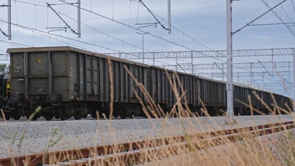 Long Haul Freight Train with Empty Cargo Railroad Cars Parked at Industrial Railway Siding Waiting...