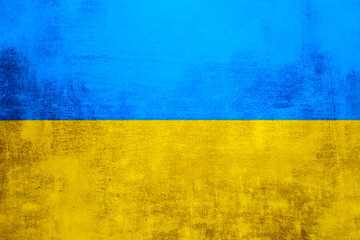 The wall is in the colors of the Ukrainian national flag - blue and yellow. Abstract texture background of concrete stone wall. Ukrainian flag on a grunge wall in connection with the war with Russia.