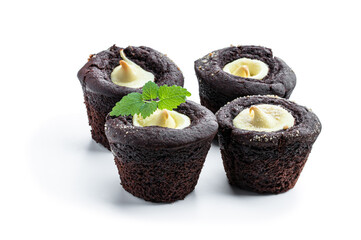 Chocolate muffins with yellow cream filling isolated on white