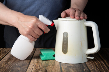 Cleaning a plastic white kettle with special chemicals.House cleaning.