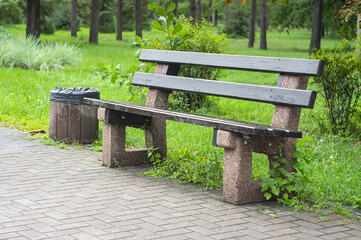 Wooden bench in the city park. Garden Bench in park with trees.