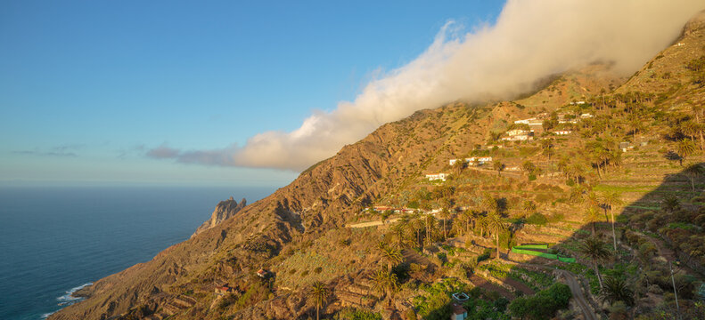 Panorama of a volcanic landscape with terraces and farms on a slope on the north coast of the isle of La Gomera, Spain