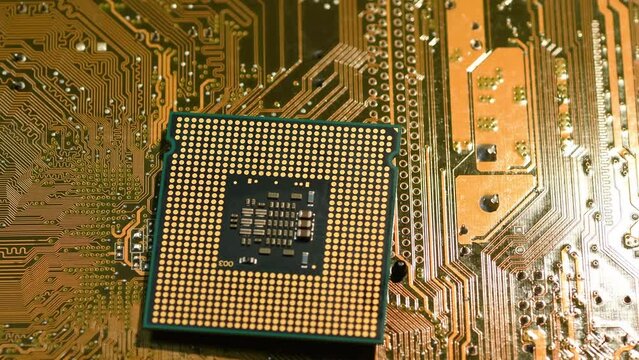 Close-up of computer processor over printed electronic circuit board rotating on dolly