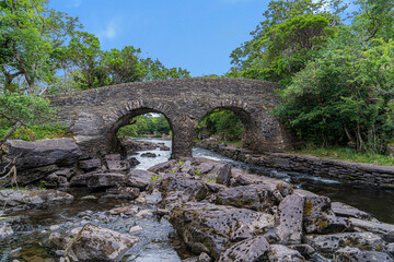 Fototapeta na wymiar Meeting of the Waters, Killarney. the best hidden gem. This is the point where all of Killarney’s three glorious lakes merge together, the upper lake, Muckross Lake and Lough Leane. Old Weir Bridge.