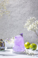 Lavender Gin and Tonic Punch Cocktail. Elegant glass filled with violet cocktail or mocktails
