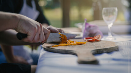 Close up photo of male hands is preparing wonderful fresh salad. Chef cooking food cutting prepare hands knife preparing vegetables.