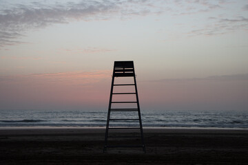 lifeguard chair at seaside with sunset