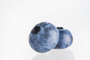 Blueberry. Two ripe blueberries isolated on white background. Ready-to-eat food, sweet dessert,...