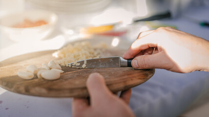 Close up photo of male hands is preparing wonderful fresh salad. Chef cooking food cutting prepare hands knife preparing vegetables.