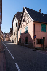 Fototapeta na wymiar Boersch, France - 09 02 2022: View of traditional Alsatian houses facades