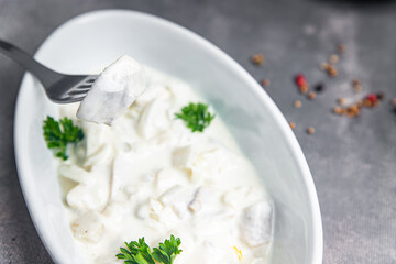 herring fish seafood white sauce sour creamfresh healthy meal food snack on the table copy space food background