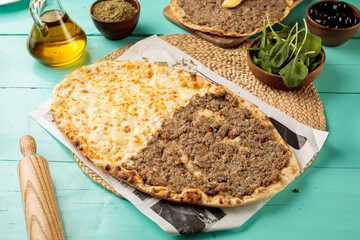 Half Laham Beajin Half Cheese Mashrooha or Lahembajin served in a dish isolated on wooden table side view of middle eastern food