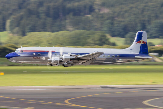 The beautiful restored Douglas DC-6 of the Flying Bulls fleet taking off in Zeltweg in Austria