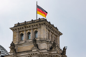 Fototapeta na wymiar The tower of Reichstag with German flag in German capital Berlin, Germany