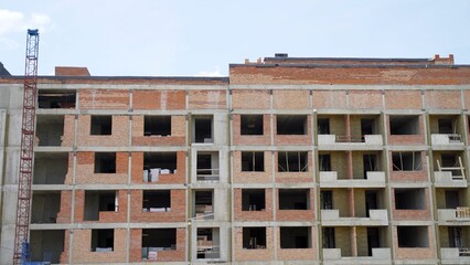 Stage of construction of a multi-storey building. Unfinished multi-storey building. Brick building...