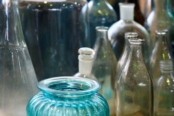 Old glass bottles collection. Group of small old glass green bottles, once used in pharmacy to contain medicine