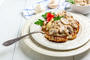 Cauliflower steak with mushrooms. Vegetarian cuisine.