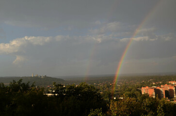 Rainbow in the city against the backdrop of the monastery.