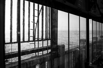 abandoned small environment with glass, frames and railings nearby the sea
