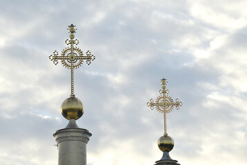 Fototapeta na wymiar Golden crosses on the background of clouds