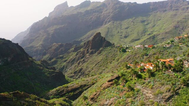 Epic and inspiring drone footage in Teno National Park. Mountain range in famous village and gorge Masca. Amazing scenery landscape covered with misty fog and clouds, haze. Nature. Tenerife, Spain.