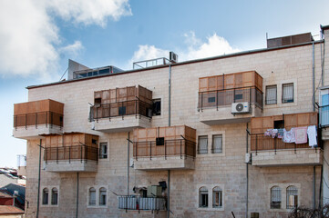Fototapeta premium View of a residential building in Israel during Sukkot, in which temporary, wooden structures are placed on balconies as part of the ritual observance of the weeklong holiday.