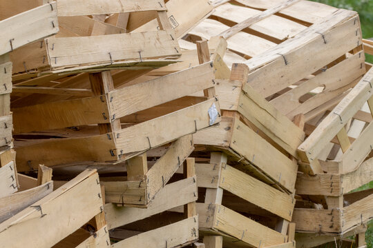 Stacked empty wooden fruit crates in agricultural setting