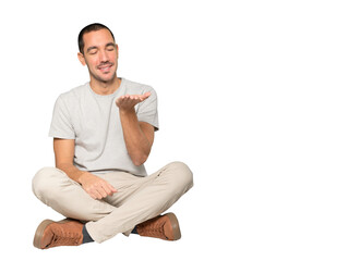 Happy young man holding something with his hand