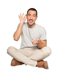 Happy young man smiling and making a gesture of trying to hear something