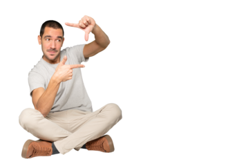 Amazed young man making a gesture of taking a photo with the hands