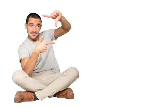 Amazed young man making a gesture of taking a photo with the hands