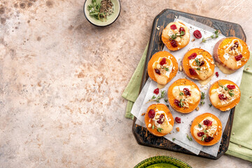 Baked Sweet Potato Rounds topped with brie cheese, cranberry and Walnut. Thanksgiving appetizer...