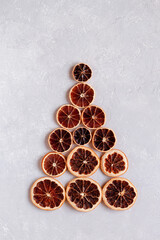 Christmas tree created of dry orange slices, minimalism