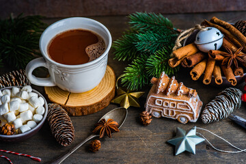 Christmas holiday decorations near mug with hot chocolate