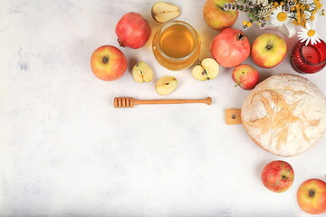 Autumn composition with apples, honey, pomegranate and flowers. Harvest concept and hello autumn,...