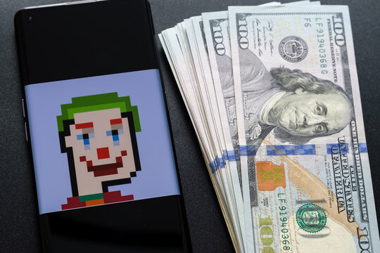 NFT TPUNK #3442 (Tron Punk) digital art from Tpunks collection seen on smartphone screen and dollar banknotes next to it. Concept. Stafford, United Kingdom, September 11, 2022.