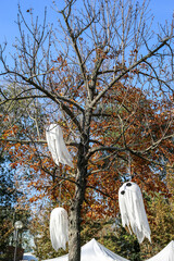 white ghosts on a tree. decorations for the Halloween holiday