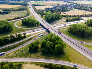 Top view of cars driving on round intersection in city. Aerial view of road in Germany