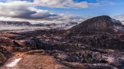 The Krafla Lava Fields Leirhnukur Hot Spring Area Iceland.Black lava and steam.