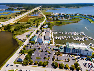 View on bay with marina, hotels, parking with cars and yachts. View from above.