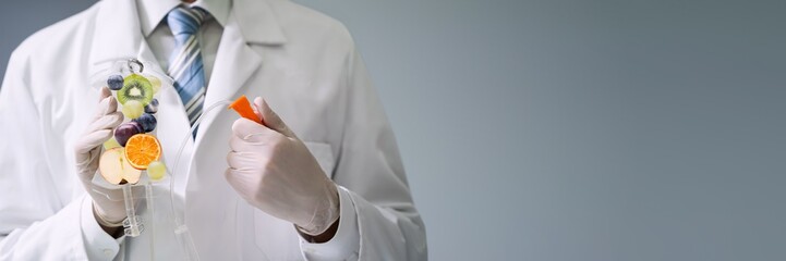 Doctor Holding Saline Bag With Fruit Slices Inside In Hospital