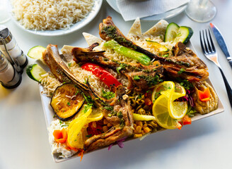 Grilled lamb traditionally served with rice, vegetables and hummus. Popular Arabic dish