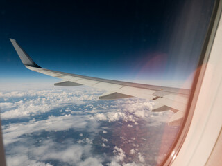 View from the window on the wing of the plane and passing clouds