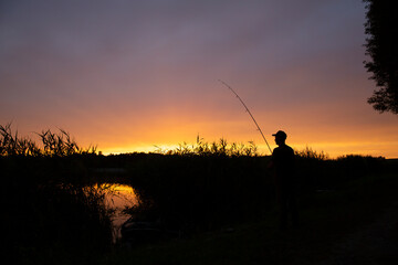 Angling fish fishing against the background of sunset
