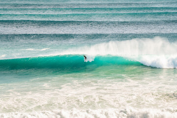 A surfer riding a wave on a long barrel on the Gold Coast