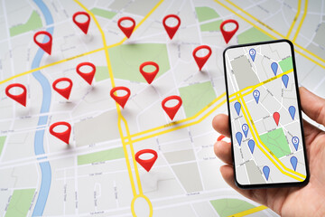 Person Holding Mobile Phone Against Map With Navigation Icons