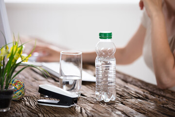Water Bottle And Drinking Glass On Desk